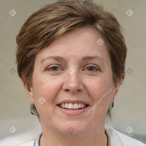 Joyful white adult female with short  brown hair and blue eyes