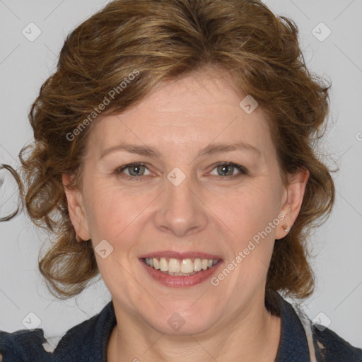 Joyful white adult female with medium  brown hair and blue eyes