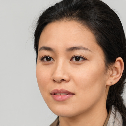 Joyful asian young-adult female with medium  brown hair and brown eyes