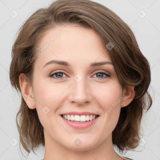 Joyful white young-adult female with medium  brown hair and green eyes