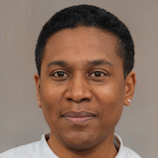 Joyful latino adult male with short  black hair and brown eyes