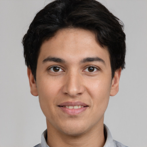 Joyful white young-adult male with short  black hair and brown eyes