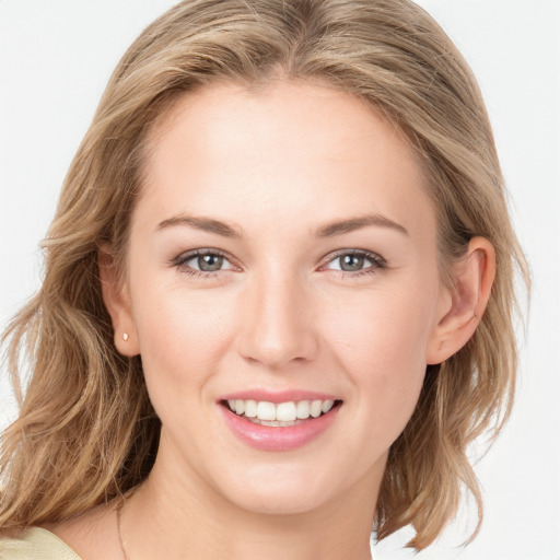 Joyful white young-adult female with medium  brown hair and blue eyes