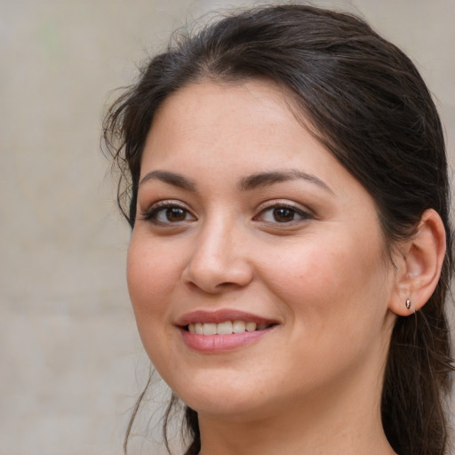 Joyful white young-adult female with long  brown hair and brown eyes