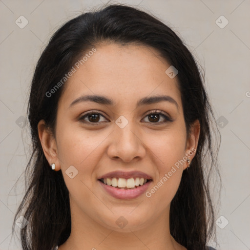 Joyful latino young-adult female with long  brown hair and brown eyes