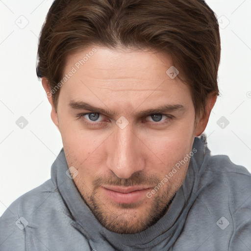 Joyful white young-adult male with short  brown hair and grey eyes