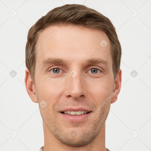 Joyful white young-adult male with short  brown hair and grey eyes