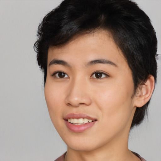 Joyful asian young-adult female with short  brown hair and brown eyes