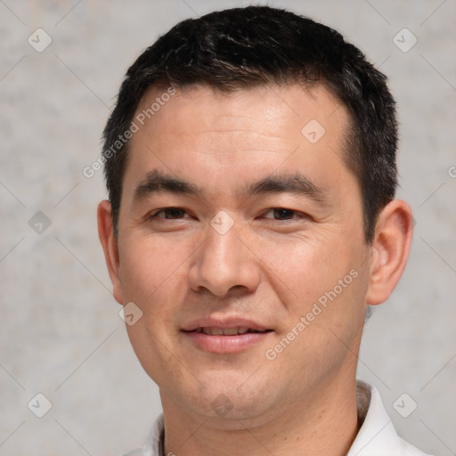 Joyful white young-adult male with short  black hair and brown eyes