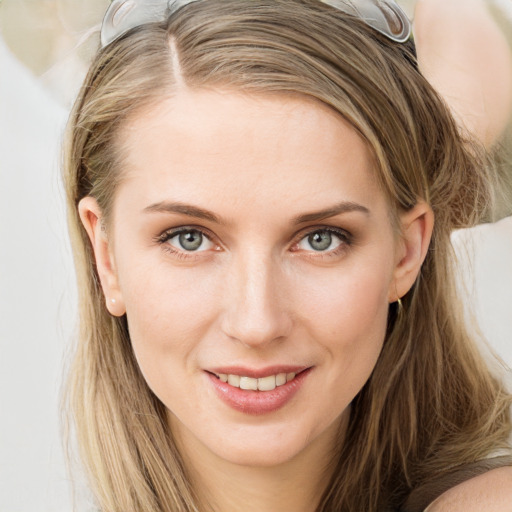 Joyful white young-adult female with long  brown hair and blue eyes