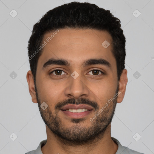 Joyful latino young-adult male with short  black hair and brown eyes