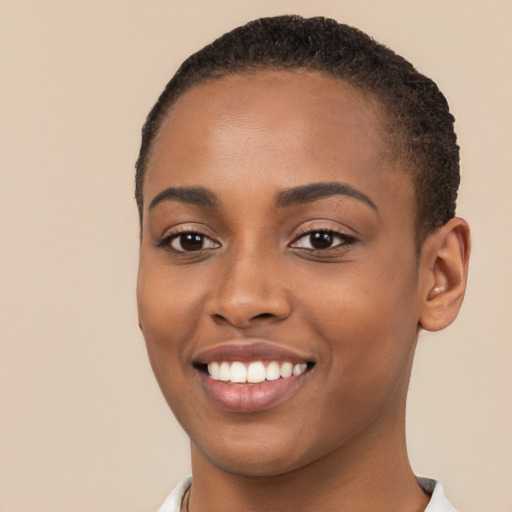 Joyful black young-adult female with short  brown hair and brown eyes