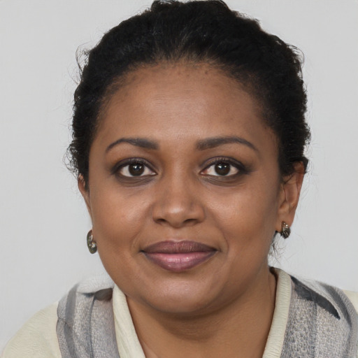 Joyful black young-adult female with short  brown hair and brown eyes