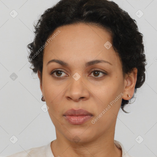 Joyful black adult female with short  brown hair and brown eyes