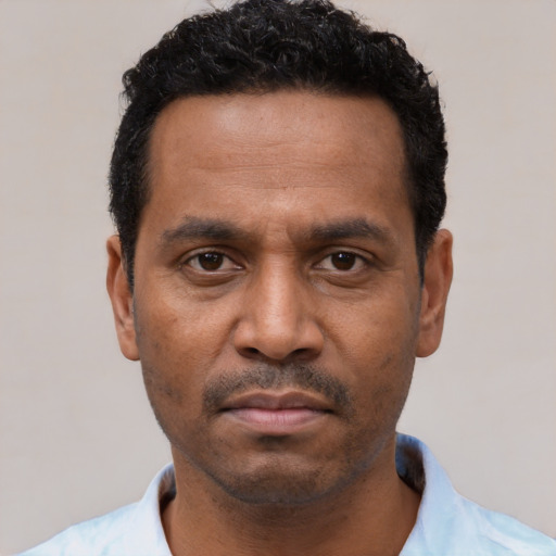 Neutral latino adult male with short  black hair and brown eyes