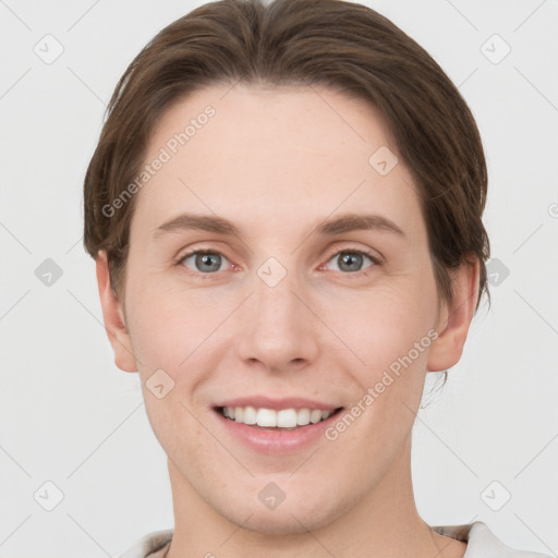 Joyful white young-adult female with short  brown hair and grey eyes