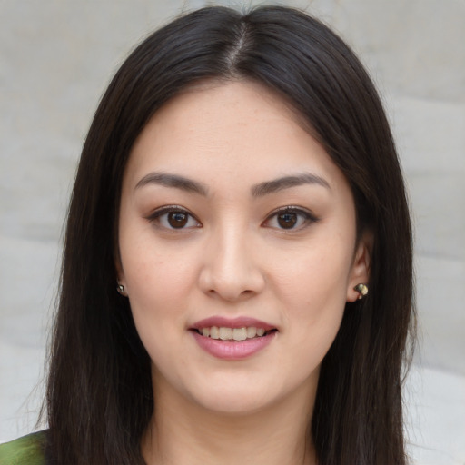 Joyful asian young-adult female with long  brown hair and brown eyes