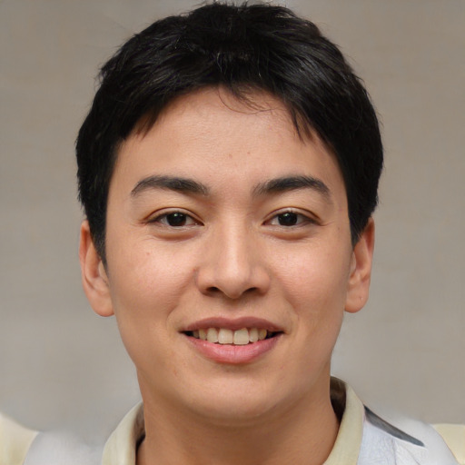 Joyful asian young-adult male with short  brown hair and brown eyes