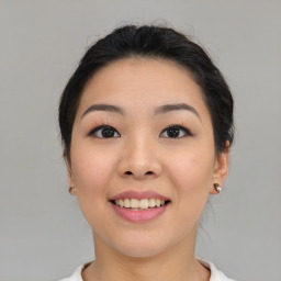 Joyful asian young-adult female with medium  black hair and brown eyes