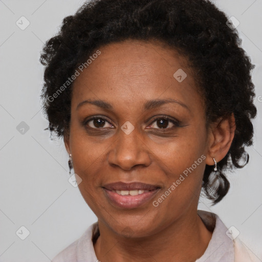 Joyful black adult female with short  brown hair and brown eyes