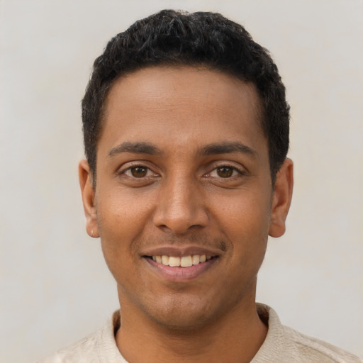 Joyful latino young-adult male with short  black hair and brown eyes