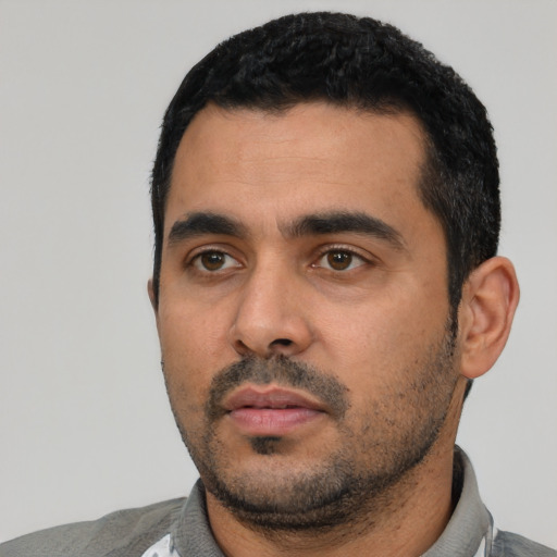 Neutral latino young-adult male with short  black hair and brown eyes