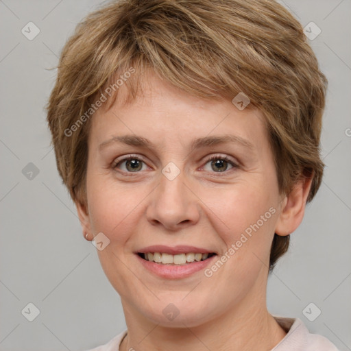 Joyful white adult female with short  brown hair and grey eyes