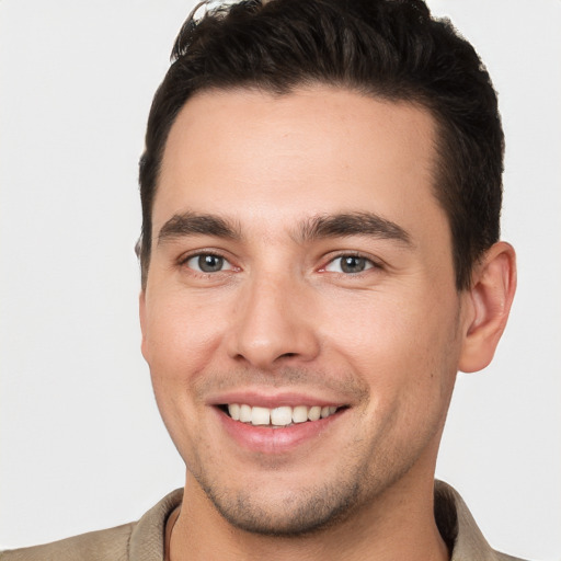 Joyful white young-adult male with short  brown hair and brown eyes