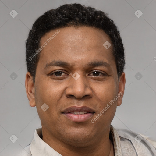 Joyful latino adult male with short  brown hair and brown eyes