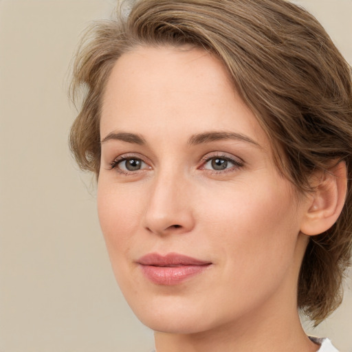 Joyful white young-adult female with medium  brown hair and green eyes