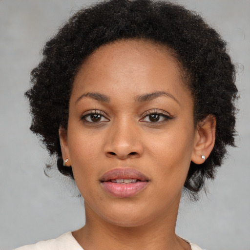 Joyful black young-adult female with short  brown hair and brown eyes