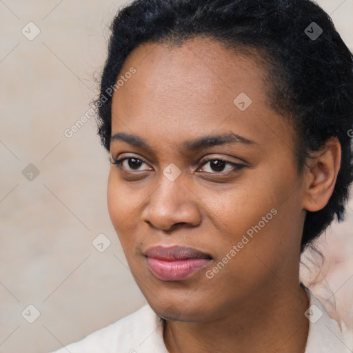 Joyful black young-adult female with short  black hair and brown eyes