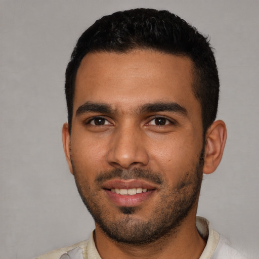 Joyful latino young-adult male with short  black hair and brown eyes