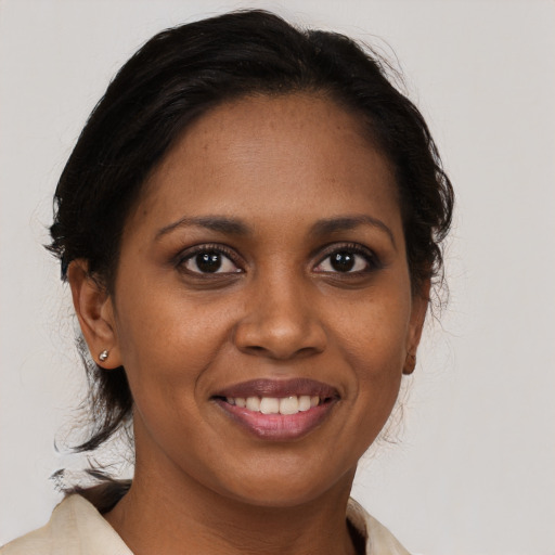 Joyful black young-adult female with medium  brown hair and brown eyes