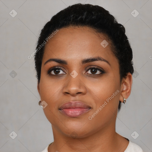 Joyful black young-adult female with short  black hair and brown eyes