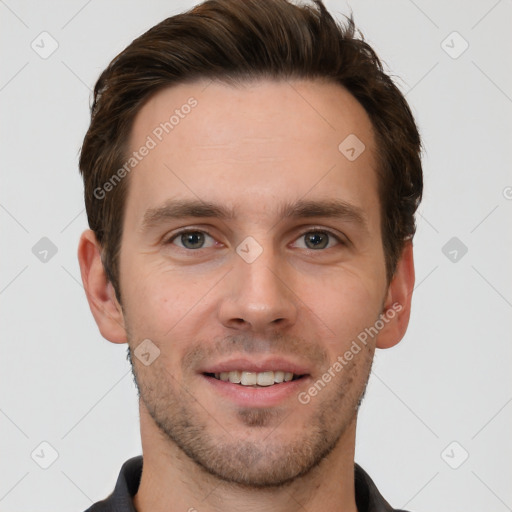 Joyful white young-adult male with short  brown hair and grey eyes