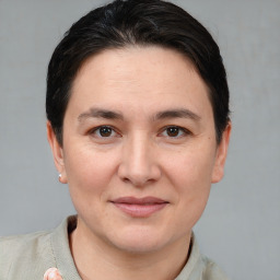 Joyful white adult female with short  brown hair and brown eyes