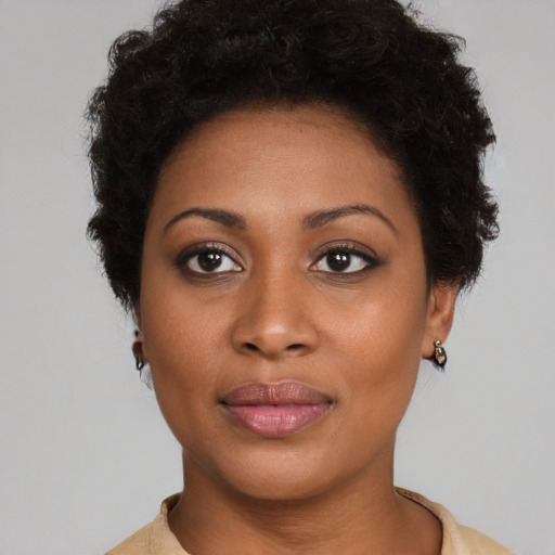 Joyful black young-adult female with short  brown hair and brown eyes