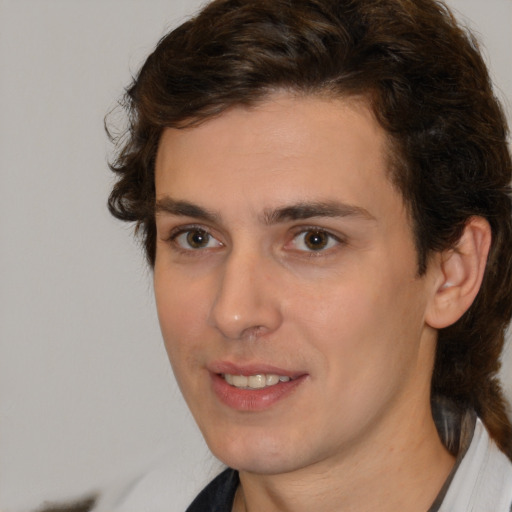 Joyful white young-adult male with medium  brown hair and brown eyes