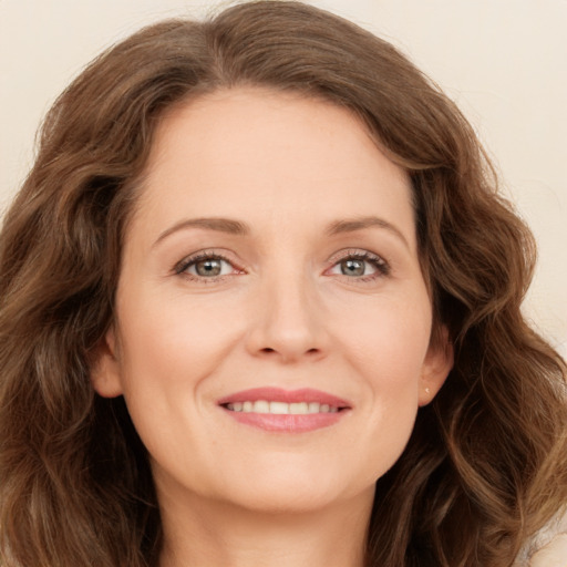 Joyful white young-adult female with long  brown hair and green eyes