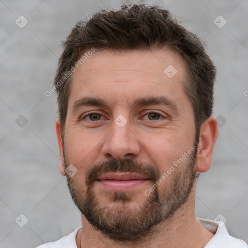 Joyful white adult male with short  brown hair and brown eyes