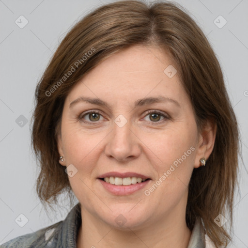 Joyful white adult female with medium  brown hair and grey eyes