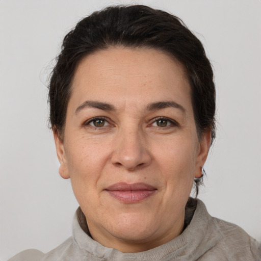 Joyful white adult female with short  brown hair and brown eyes