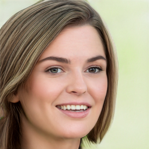 Joyful white young-adult female with long  brown hair and green eyes