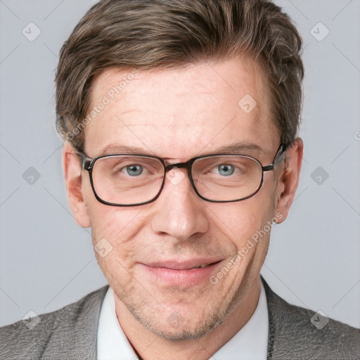 Joyful white adult male with short  brown hair and blue eyes