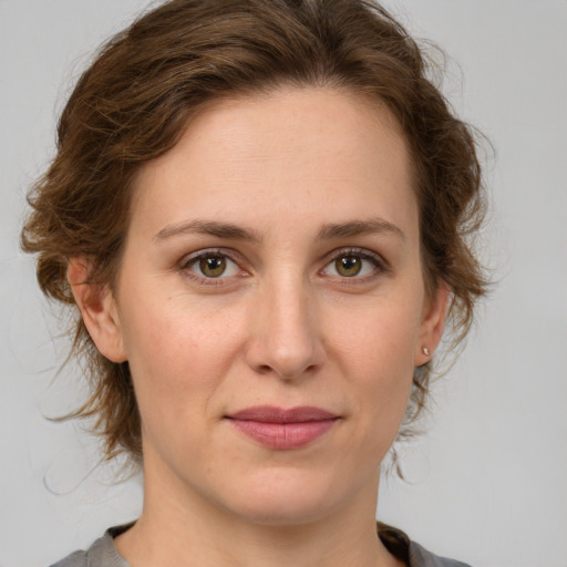 Joyful white young-adult female with medium  brown hair and green eyes