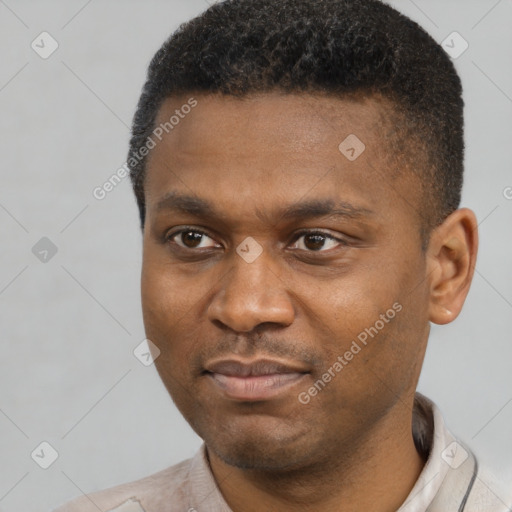 Joyful black young-adult male with short  black hair and brown eyes