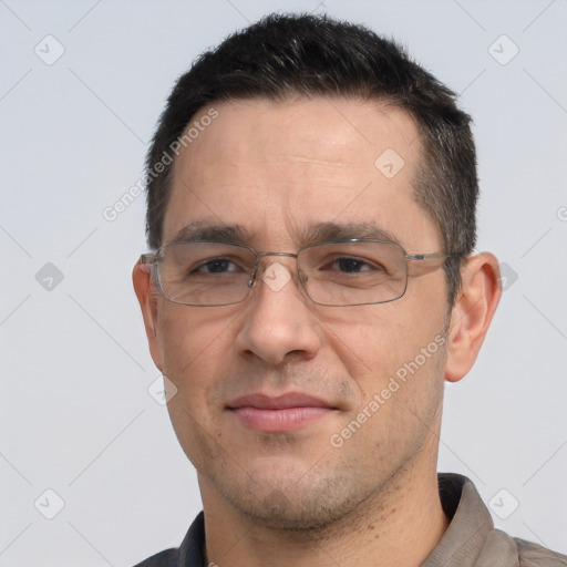 Joyful white adult male with short  black hair and brown eyes