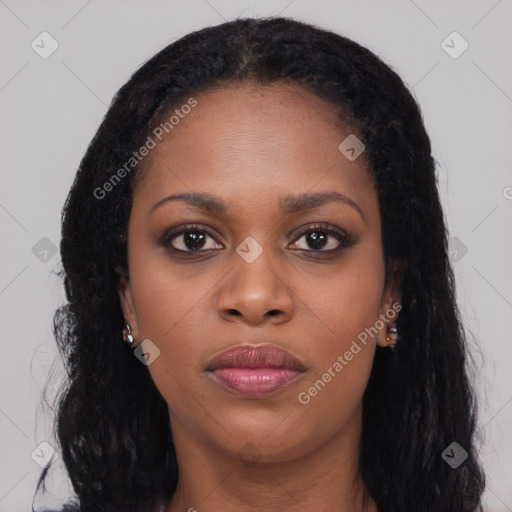 Joyful black young-adult female with long  black hair and brown eyes