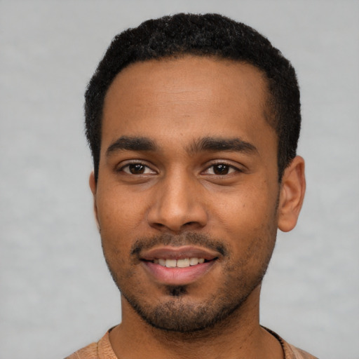 Joyful black young-adult male with short  black hair and brown eyes